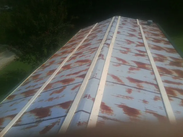 Rusted metal roof panels with new wood purlins before replacement — Storm Damage Roof Repair in Beacon by Roofing Brothers