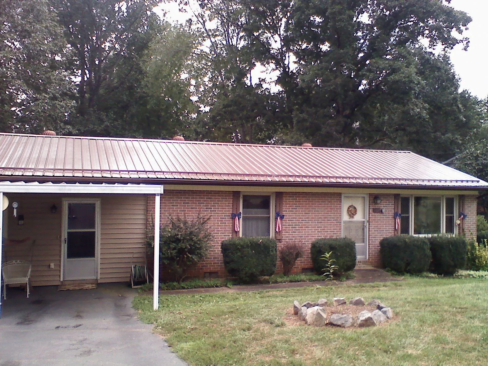 Bronze metal roof and carport on a brick ranch home — Roof Repair work by our crew in Beacon