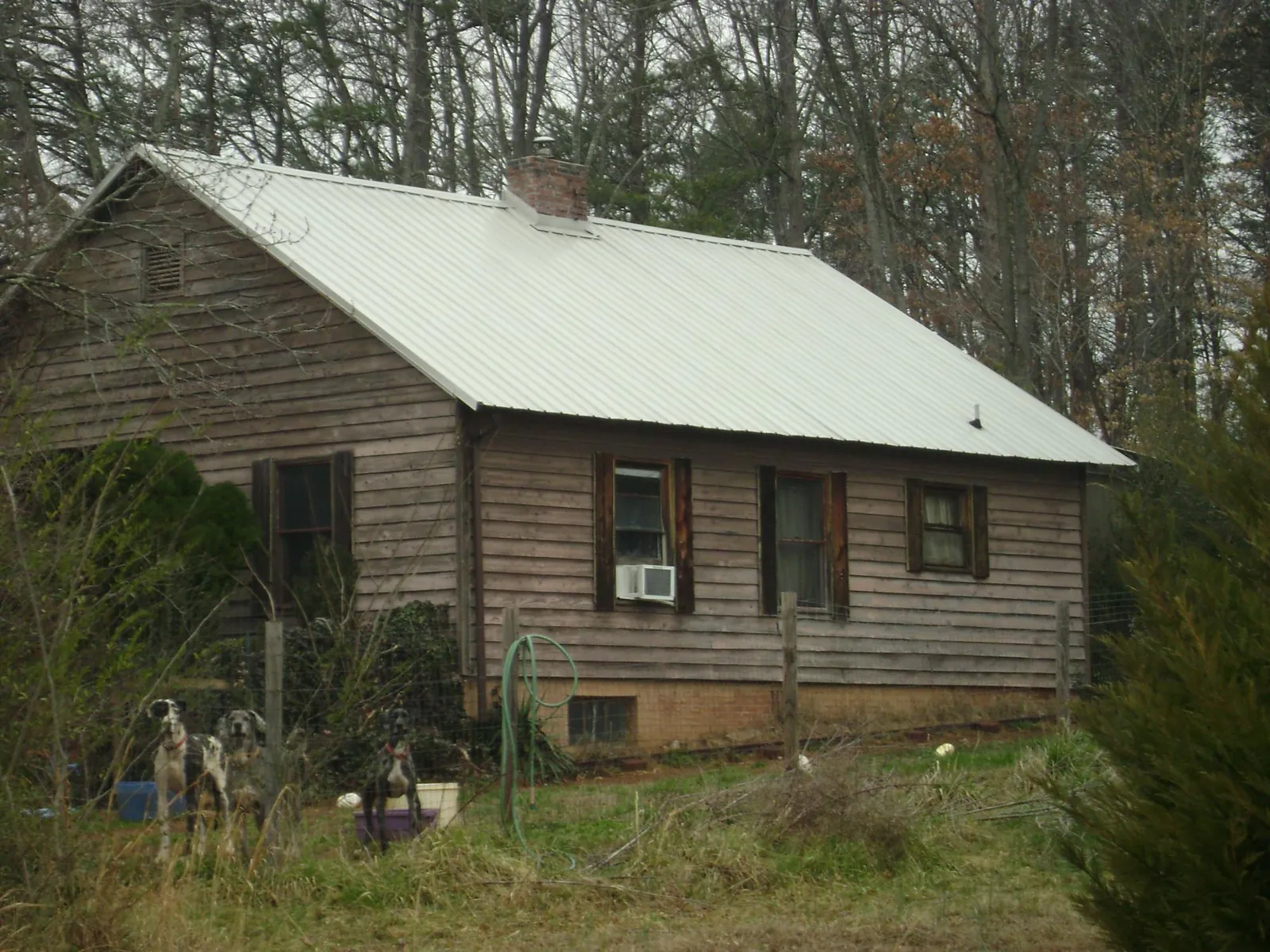 White metal roof on an old wood sided farmhouse, from a Metal Roof Installation job in Beacon